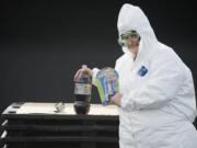 Columbian reporter Sue Vorenberg prepares to set off a diet-soda geyser.