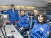 From left, Anna-Melissa Lyons, Robert Black, Dave Bloomsness and Kim Abegglen check out the equipment aboard NASA's 747SP.