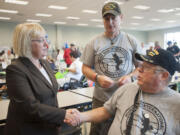 Sen. Patty Murray meets with veterans Clint McCourtney, right,  and Paul Sluznis at the annual veterans stand-down in Vancouver on Aug.