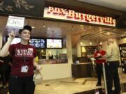 Laurin Radcliffe delivers food at the airport location of Burgerville, near Gate D6.