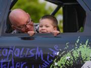 Gideon Janku, 4, sits in a monster truck with his dad, Scott Janku, during a special car show organized just for him May 16 in the East Vancouver Home Depot parking lot.