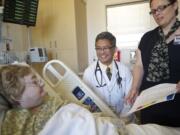 Dr. Hoa Ly, center, and registered nurse Susan Frederick discuss follow-up instructions with heart failure patient Marilyn Wright, 64, of Vancouver before discharging her from Legacy Salmon Creek Medical Center on Wednesday.