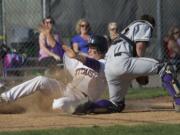 Union base runner Jack Bauer slides past Battle Ground catcher Gunner Talkington to score the game-tying run.