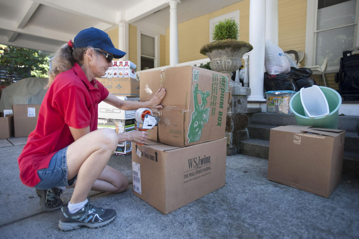 DeAnn Miller packs  boxes filled with donations made to give wildfire victims in Vancouver, Thursday September 10, 2015. The donations will be delivered to the affected areas.