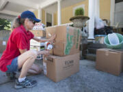 DeAnn Miller packs  boxes filled with donations made to give wildfire victims in Vancouver, Thursday September 10, 2015. The donations will be delivered to the affected areas.