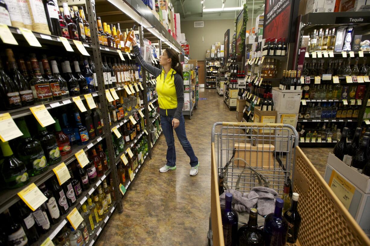 A shopper makes a liquor purchase at Total Wine &amp; More, among the spirit-selling newcomers that saw business potential opportunities in Clark County after a voter-approved measure privatized Washington's former state-run liquor system.