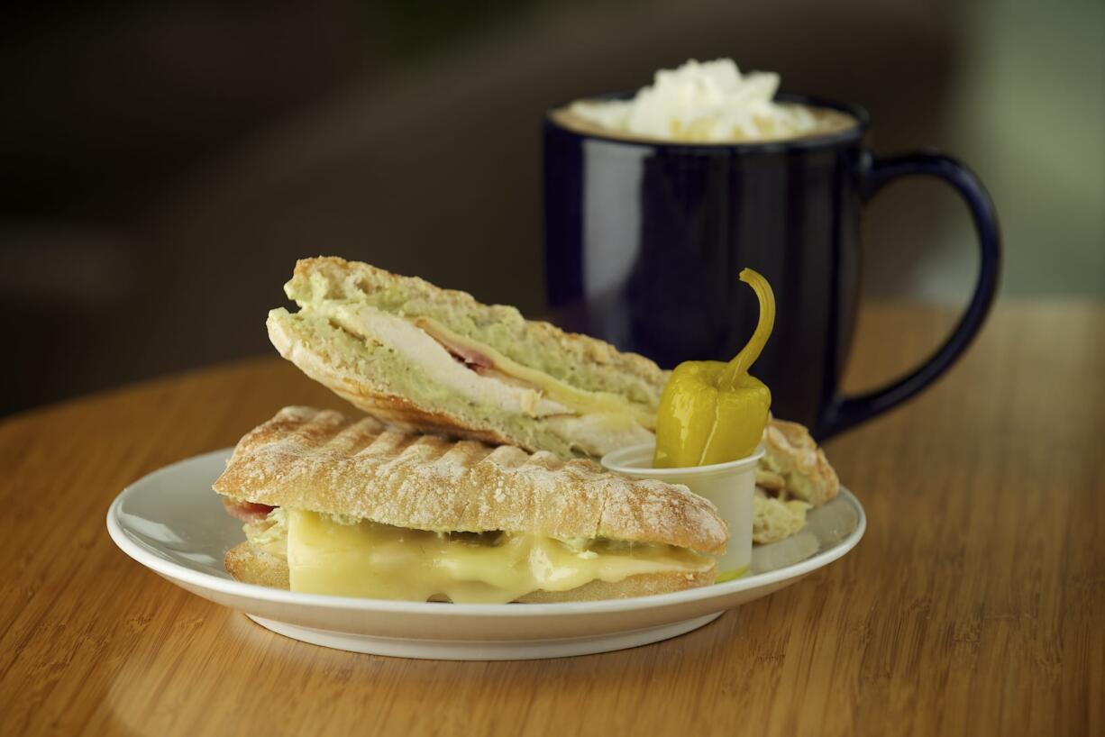 A ghiotto panino, made with bacon, chicken, avocado dressing and havarti cheese, and a black-and-white mocha are available to order at Coffee Villa in Vancouver.