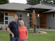 John Taylor, owner of Modern Home Design & Build, and his wife, Julie Wilcox, stand in front of The Hyfield, one of five homes included in this year’s NW Natural Parade of Homes, which opens Friday and runs through Sept. 20. Taylor says his home designs are reminiscent of the midcentury architecture of Southern California.