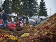 People line up to take advantage of an opportunity to dump leaves for free with a coupon offered from the city of Vancouver and Clark County at H& H Wood Recyclers in 2011.