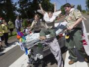 Jackson Sinclair, center, of Boy Scout Troop 359 celebrates as his team crosses the finish line during Saturday's bed races at Hockinson Fun Days.