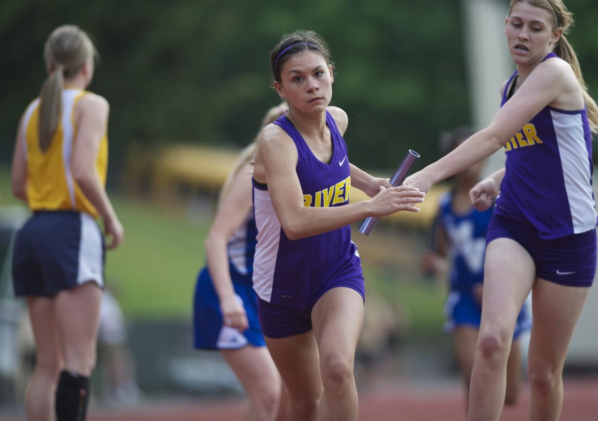 Columbia River's Taylor Hallquist takes the baton as the anchor for a first-place finish in the 1,600-meter relay at the 3A district track and field meet at McKenzie Stadium.