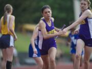 Columbia River's Taylor Hallquist takes the baton as the anchor for a first-place finish in the 1,600-meter relay at the 3A district track and field meet at McKenzie Stadium.