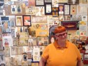 Artist Mar Goman stands before &quot;The Wall,&quot; a series of postal art she sent to her friend Jack Danger over the past 15 years, which is on display at her new show at North Bank Gallery through May 31.