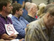 Information technology consultant Rory Bowman, holding a sign during a Port of Vancouver commission meeting Tuesday, told the commission that approving the oil terminal would not be a wise decision for Vancouver.