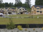 Crews work at the Hills at Round Lake, a new 333-lot housing development in Camas.