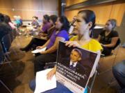 Gloria Torres of Vancouver attends a OneAmerica town hall meeting at the Vancouver Community Library on Thursday to show her support for changes to the nation's immigration policies.