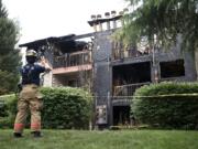 Fire officials investigate a fatal fire at the Sunpointe Apartments on Thursday.