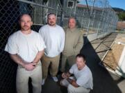 Larch Corrections Center offenders Michael Skinner, from left, Clayton Chapin, Walt Beasley, and Marcus Smith gather Friday to discuss their roles as part of a 17-man crew that helped feed rescue and recovery workers for two weeks at the scene of the massive March 22 landslide near Oso.