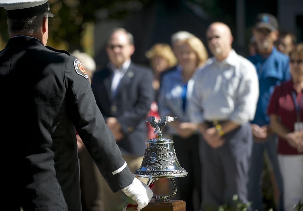 Zachary Kaufman/The Columbian
Vancouver Fire Capt. Perry LeDoux rings a bell to honor those who were lost on Sept.11, 2001.