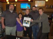 Camas: Downtown Camas Association Executive Director Carrie Schulstad presents Mill City Brew Werks owners and staff with the Excellence on Main Street Economic Vitality Award from the Washington State Main Street Program.