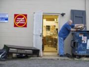 Norm Wilmot, a volunteer for Clark County Adventist Community Services, recycles cardboard after finding a pile of rubbish outside the organization’s door the morning of Aug. 31.