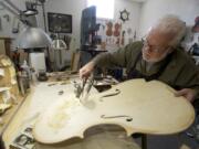 Photos by Steven Lane/The Columbian
Mark Moreland works on the body of a cello in his Battle Ground shop April 18.