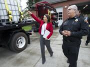 U.S. Sen. Maria Cantwell, D-Wash., walks past a firefighting rig with Vancouver Fire Department Division Chief Steve Eldred during a visit to Vancouver on Wednesday.