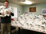 Vancouver: iQ Credit Union Development Director Matthew Butte holds mustached and stuffed polar bears that were collected for charities during the credit union's recent &quot;Get a Loan, Give Some Love&quot; promotion.