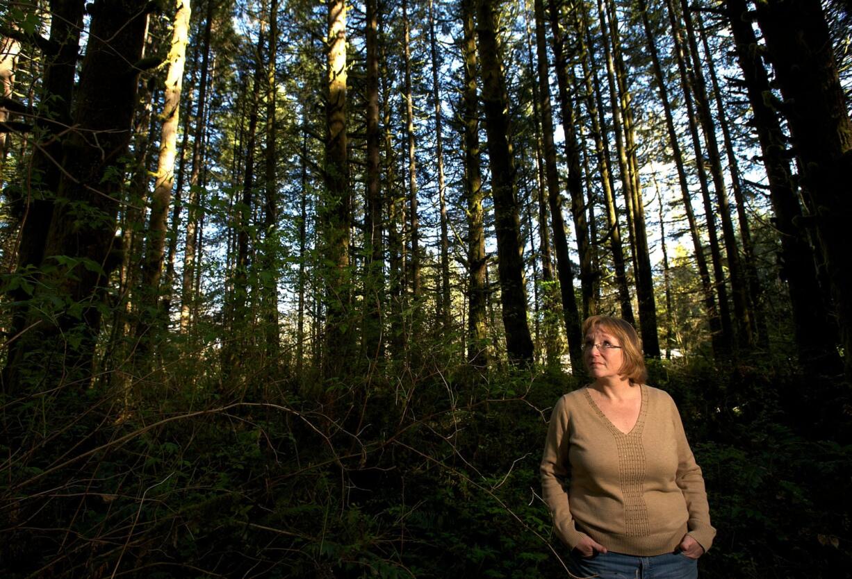 Norma Countryman stands on April 9 in the spot east of Battle Ground where she says she was tied to a tree after Warren Forrest abducted her. Suspected of being a serial killer, Forrest had a parole hearing in February.