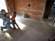 Patricia Kent shares a moment with her children Quintin, 2, and Cadence, 5 months, as she gives a tour of the property in east Clark County's Proebstel neighborhood she and her fiance hope to turn into their dream home.