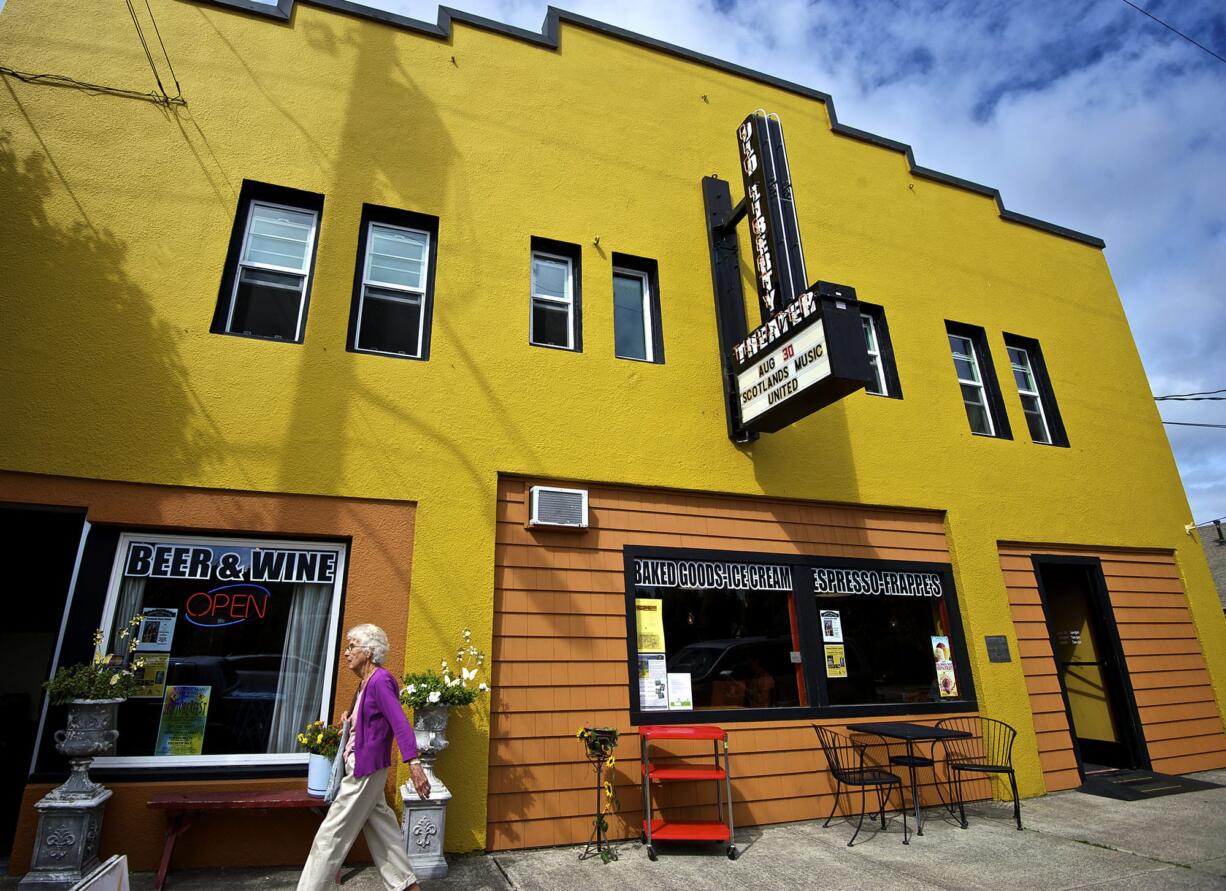 A woman strolls Friday past the Old Liberty Theater in downtown Ridgefield.