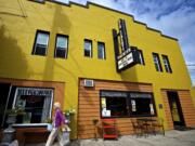 A woman strolls Friday past the Old Liberty Theater in downtown Ridgefield.