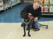 Harry Kiick, who has severe seizures, trains his new service dog, Carter, at a Petco store in Southeast Vancouver.