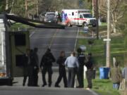 Law enforcement surrounds a Ridgefield home Friday afternoon looking for Derral Kenneth &quot;Kenny&quot; Mosby, a wanted fugitive who was shot during the standoff.