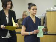 Attorney Megan Peyton, left, and Kalista Andino, 21, exit arraignment court in Vancouver.