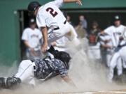 Union's Ethan Beniga jumps over Todd Beamer's catcher Kepa Sharpe to open the scoring in the first inning in a 4A bi-district playoff game.