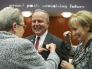 Chuck Atkins' mother, Vivian Atkins, pins the sheriff's star to her son's lapel at a Monday afternoon ceremony. Atkins is the first new sheriff in 24 years.