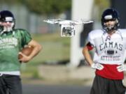 Parent volunteer Matt Codino pilots a drone to record football practice at Camas High School, Wednesday, September 10, 2014.