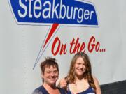 Tina Condon, left, and her daughter Tiffany Castano-Sawyer stand in front of their new food trailer venture, Steakburger on the Go.