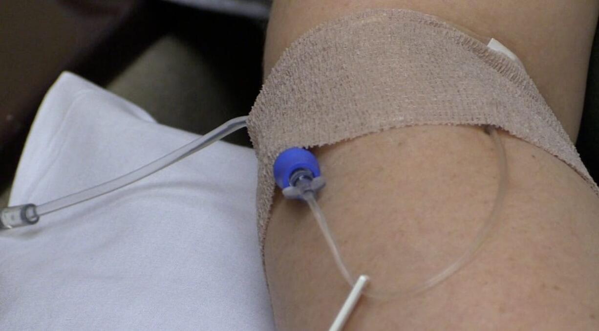 Valerie Miles, who has two brain tumors, receives her final infusion of the vaccine, ADU-623.