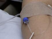 Valerie Miles, who has two brain tumors, receives her final infusion of the vaccine, ADU-623.