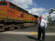 Washougal Mayor Sean Guard waits for a train to pass near the intersection of Main and 32nd streets.