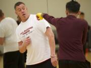 Tony Adams, founder of Mind Fitness Attitude Boxing instructs a boxing student during a Friday afternoon class at LA Fitness in Vancouver.