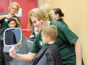 Hairstylists donated their time to provide free haircuts during the Compassion Ridgefield event at View Ridge Middle School last year. Stylists provided 92 free hair cuts during the 2014 event.