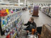 Eric Burgstahler of a Hi-School Pharmacy helps set up a display for merchandise at the company’s new store in the Minnehaha area. The store is set to open Sept. 20, more than a dozen years after Hi-School Pharmacy sold its Clark County stores.