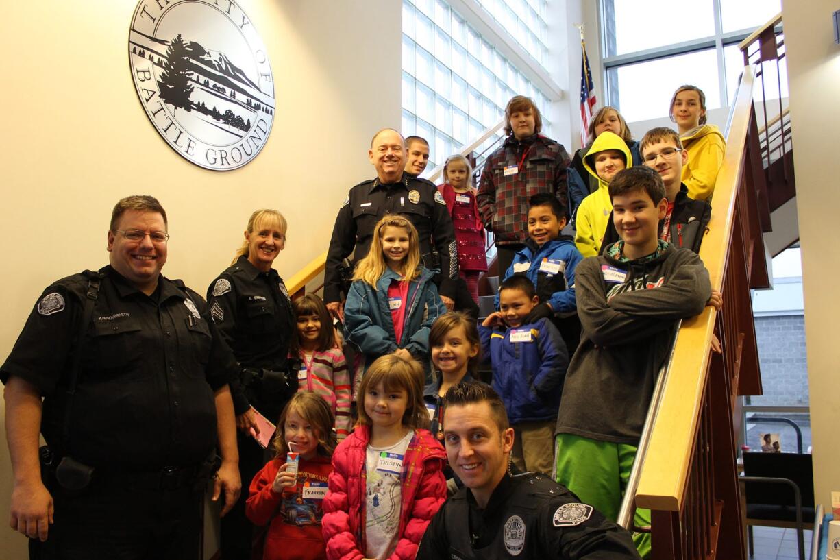 Battle Ground: Police officers and kids are all smiles as they get ready to go shopping on Dec.