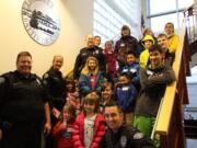 Battle Ground: Police officers and kids are all smiles as they get ready to go shopping on Dec.