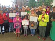 Esther Short: Community members take part in an interfaith peace vigil Saturday at Esther Short Park. The event was in remembrance of the Pakistani children and their teachers who were killed by the Taliban on Dec.