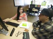 Ashley Bowers, left, a tax associate at H&amp;R Block, helps James Griffin of Vancouver with his tax returns Monday at the tax firm's Main Street office. Griffin, a salesperson, and said his biggest worry every tax season is whether he owes money or not.