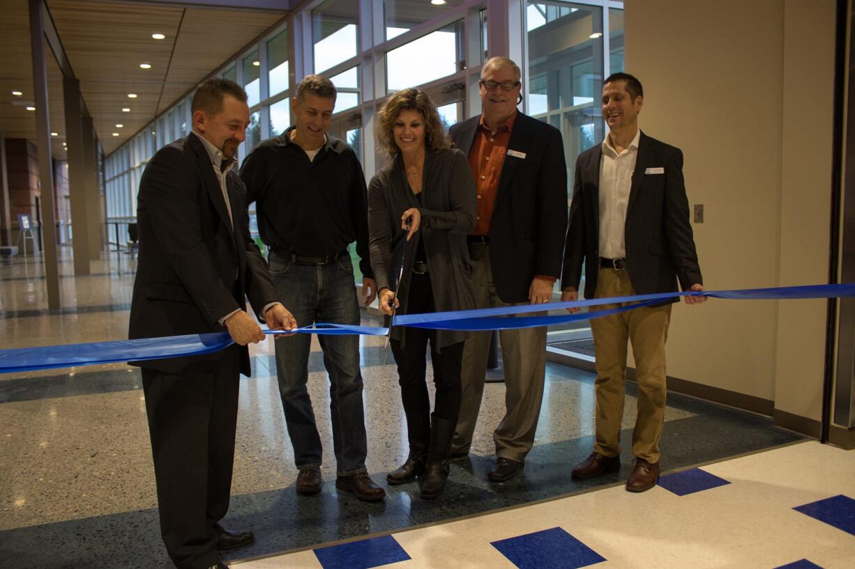 Ridgefield: Ridgefield School District board members Scott Gullickson, from left, Steve Radosevich, Becky Greenwald and Jeff Vigue cut a ribbon with Superintendent Nathan McCann at a Dec.